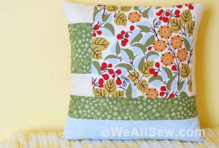 Is that big, bold scrap of fabric staring at you? This quilt square is designed to let a large print fabric shine. This simple block is quick to make and easily stitched into a pillow. With a bit more fabric you can turn it into a placemat or table runner. The perfect project for turning fabric scraps into something bold and beautiful. Geometric Quilt Block Pillow Supplies Large scraps or fat quarters of 100% cotton quilter's fabrics: One large print One light solid or small print One medium solid or small print One dark solid or small print 1/2 yard of white cotton fabric for the pillow lining 1/2 yard of fabric for the pillow back Coordinating thread 14" square pillow form Universal or Sharp needle, size 75/11 1/4" foot (BERNINA Patchwork Foot with Guide #57) Straight stitch foot (BERNINA Straight Stitch Foot #13) Zigzag foot (BERNINA Reverse Pattern Foot #1) or overlock foot (BERNINA Overlock Foot #2) Rotary cutter and self-healing cutting mat Clear acrylic gridded ruler Download and print the Geometric Quilt Block Pillow Cutting and Piecing Diagrams: [download id="90"] Step 1) Cut the fabric pieces. Accurate cutting helps avoid crooked, puffy, or uneven seams in your quilt block. Use a self-healing mat, a clear acrylic gridded ruler, and a rotary cutter to cut the pieces for your quilt block. Rotary cutters Rotary Cutting Tips Self-healing mats come in different sizes. 24" x 36" is a good size to have, but if you don't have a dedicated sewing space or don't plan to use it often, try an 18" x 24" mat instead. Acrylic rulers also come in many shapes and sizes. A standard 6" x 24" ruler is a good start, and I've also found a 12-1/2" x 12-1/2" square ruler to come in very handy. Rotary cutters are measured by the size of the circular blade in millimeters. A 45 mm rotary cutter is perfect for making the kind of straight cuts needed for this project. Use the grid on your cutting mat to help square up fabric pieces when needed, but when measuring to cut the pieces be sure to use the gridlines on the acrylic ruler. Hold the ruler firmly on top of the fabric, and use a steady, firm, pressing motion when cutting with the rotary cutter. Cut one of each pattern piece from the corresponding fabrics (also see downloaded Cutting Diagram): Piece #1 - Light solid or small print, 4" x 3" Piece #2 - Dark solid or small print, 4" x 5" Piece #3 - Light solid or small print, 4" x 2-1/2" Piece #4 - Large print, 9-1/2" x 9-1/2" Piece #5 - Light solid or small print, 2-1/2" x 9-1/2" Piece #6 - Dark solid or small print, 14-1/2" x 2-1/2" Piece #7 - Medium solid or small print, 14-1/2" x 3-1/2" Step 2) Piece the block. Set your sewing machine for a straight stitch about 2.5 mm long. Attach a quarter-inch foot, such as BERNINA Patchwork Foot with Guide #57, to your sewing machine. The blocks will be sewn together using a 1/4"-wide seam allowance. Stitching an accurate 1/4"-wide seam will help your block come together with nice, straight seams and avoid pieces not fitting together as you sew on. Geometric Quilt Block Pillow Patchwork Piecing Tips Us a quarter-inch foot to help you keep the correct seam allowance width. The BERNINA Patchwork Foot #37 is designed specifically so that following the edge of the foot will create a 1/4"-wide seam allowance. BERNINA Patchwork Foot with Guide #57 is similar to foot #37, but adds a metal guide at the side of the foot to help you like up your fabric piece exactly at the edge of the foot. Attach a seam guide to the bed of your sewing machine along the 1/4" seam allowance mark on your stitch plate, then place the edges of your fabric pieces against the guide as you sew. Alternatively, place a piece of blue low-tack painter's tape along the 1/4" seam allowance mark on your stitch plate as a guide for your fabric. Piecing Diagram Geometric Quilt Block Pillow Start by stitching Piece #1 to Piece #2 along one 4" edge. Press the seam allowances to one side. Next, sew Piece #3 to Piece #2 along one 4" edge as shown in the diagram; press after stitching. Geometric Quilt Block Pillow Continue adding pieces to the block as shown in the diagram, pressing each seam as you go. Tip: When pressing seams, be sure to press DOWN with the iron as opposed to "ironing," or pushing the iron back and forth over the seam. Ironing (back and forth motion) can cause straight seams to go crooked. Pressing straight up and down with the iron will help your seams stay nice and straight. Press all seams again from the back of the block when finished. Geometric Quilt Block Pillow The finished block should measure 14-1/2" x 14-1/2". Geometric Quilt Block Pillow Step 3) Construct the pillow cover. Cut one 14-1/2" x 14-1/2" square of fabric for the pillow lining. Cut two 11" x 14-1/2" rectangles of fabric for the pillow back. Create a 2" hem along one edge of each 11" x 14-1/2" pillow pocket piece: Turn under 1" along one long edge; press. Turn under an additional 1"; press. Geometric Quilt Block Pillow Topstitch close to the inner edge of the folded hem with a straight stitch, using either a multi-purpose foot or a straight stitch foot. Geometric Quilt Block Pillow Layer and pin the pieces of the pillow together: Begin with the 14-1/2" square of white cotton for the lining. Add the finished patchwork block, right side up, matching all edges. Add one pocket pillow back, right side down, matching the raw edges. The finished hem will be about 5" from the other end of the pillow. Add the other pocket pillow back, right side down, on the opposite edge. The hemmed edges will overlap. Geometric Quilt Block Pillow Pin around all four edges of the pillow. Set your sewing machine for a straight stitch of 2.5 mm long. Stitch around all four sides of the pillow using a 1/2"-wide seam allowance. Trim all seam allowances to 1/4". Attach an overlock or zigzag stitch foot to your sewing machine. Set your machine for a zigzag or overlock stitch and sew over the raw edges to keep them from unraveling. Geometric Quilt Block Pillow Turn the pillow cover right side out, gently pushing each corner from the inside to turn it. Insert the 14"-square pillow form through the opening in the back of the pillow cover. If needed, use a little fiberfill to help fill out the pillow corners. Geometric Quilt Block Pillow Geometric Quilt Block Pillow