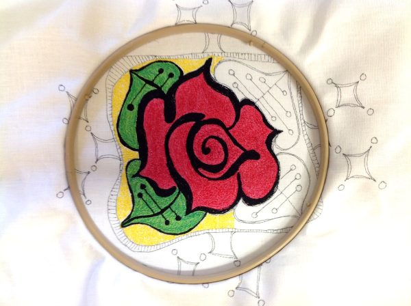Re-hoop the design to make a thread painted rose tile pillow