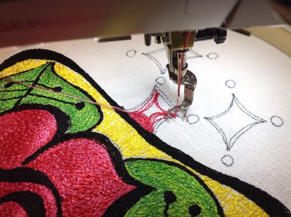 Thread paint squares to make a thread painted rose tile pillow