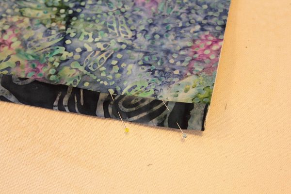 Fused Log Cabin Table Runner Tutorial - Fold the binding strips toward the back, pin in place