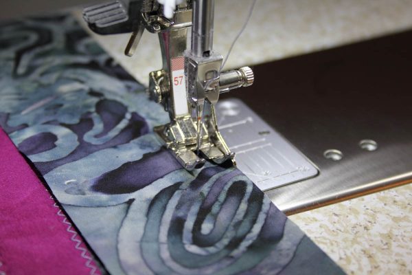 Fused Log Cabin Table Runner Tutorial - stitching each of the 2″ x 42″ strips to each long side of the runner