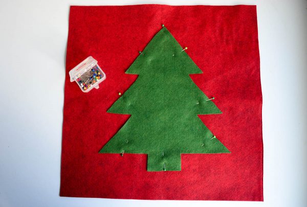 Christmas Tree Pillow Tutorial - Place the tree in the center of one of your felt squares and pin in place