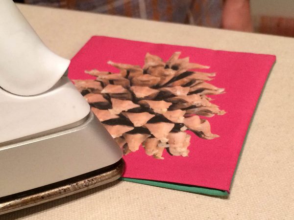 Holiday Coasters Tutorial - Carefully fold the top edge of your fabric over the insert and inside the pocket