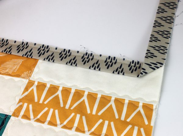 Flip the binding corner up.
