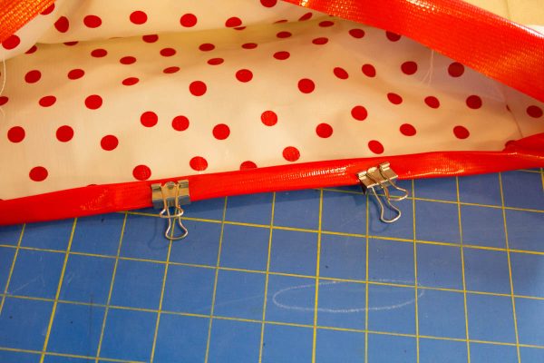 Oilcloth Garden Tote Tutorial - Use binder clips to hold the binding in place