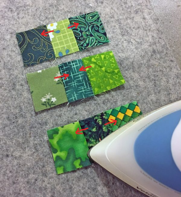 Shamrock Table Runner-Sew the scraps into three rows, then press the seams alternately