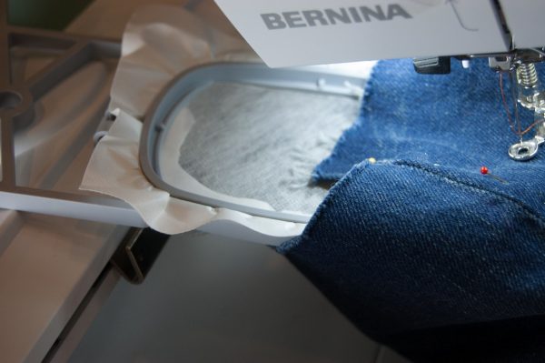 Slide the leg of the jeans over the hoop and stick to the stabilizer in the desired position