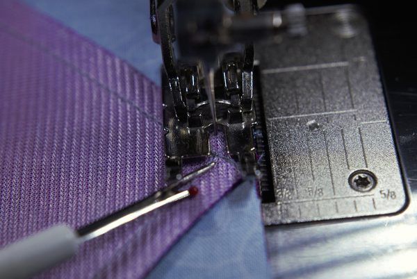 cross at the intersection of the previous seam
