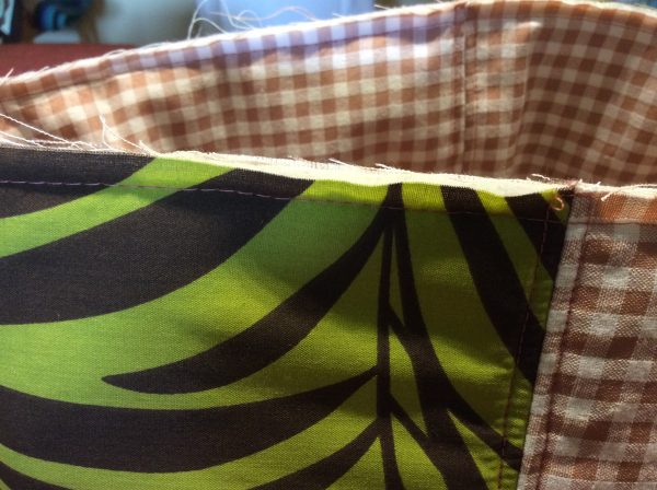 sewing the trim on the top edge of the bag
