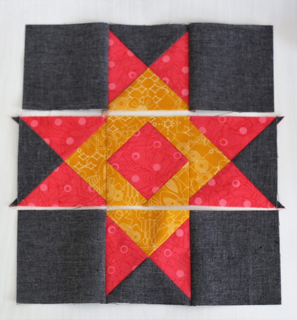 Seam together the center square in between two quarter square triangle units