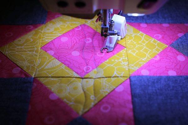 Continue to stitch gentle wavy lines to both sides of the first line