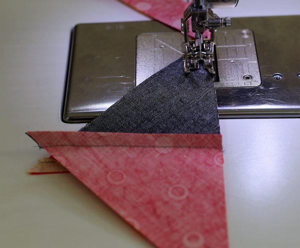 Seam the two different triangle sets together to create a square