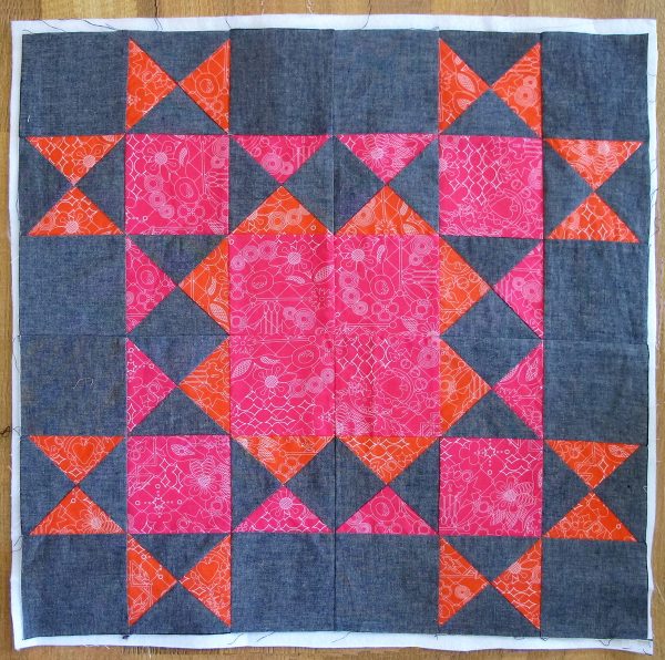 Seam the four blocks together with the pink corner square facing the center of the large 24 ½″ square