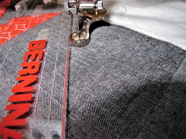 Continue to echo the straight lines by moving the ruler so the edge of the ruler is on the previous stitching line