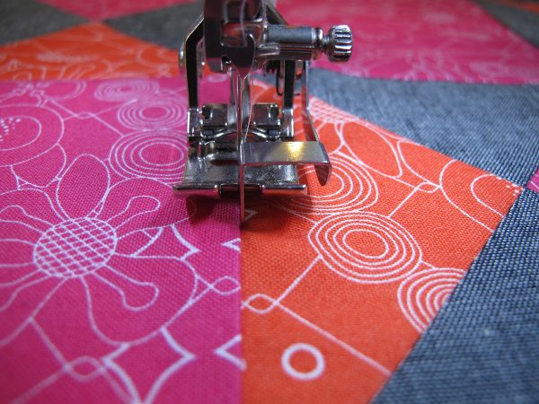 Let the guide on the sole ride in the seam and stitch