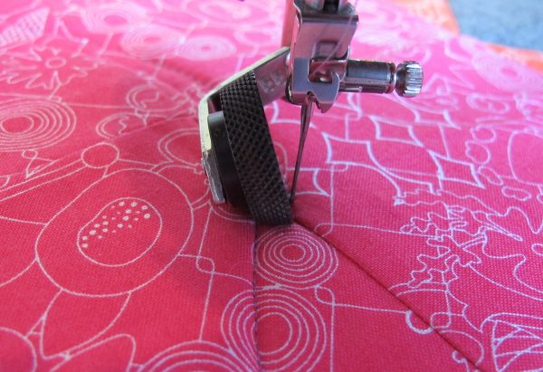 stitching a free-form curved line across the center square of the block
