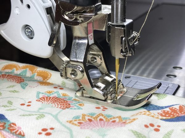 Finish the edges by quilting a double line of stitches around the edges of the placemat