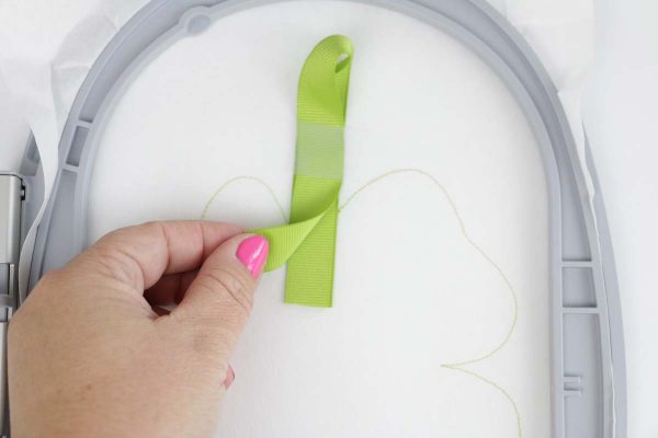 Shamrock door hanger in the hoop step three: sew stitch #1 the placement stitch and place ribbon raw edges inside stitch #1