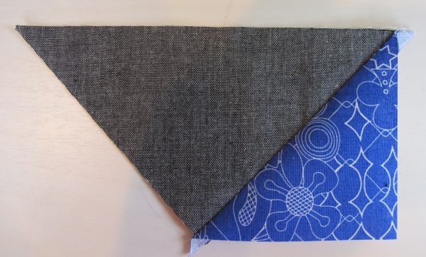 Stitch 2 Fabric C triangles to a large Fabric D triangle