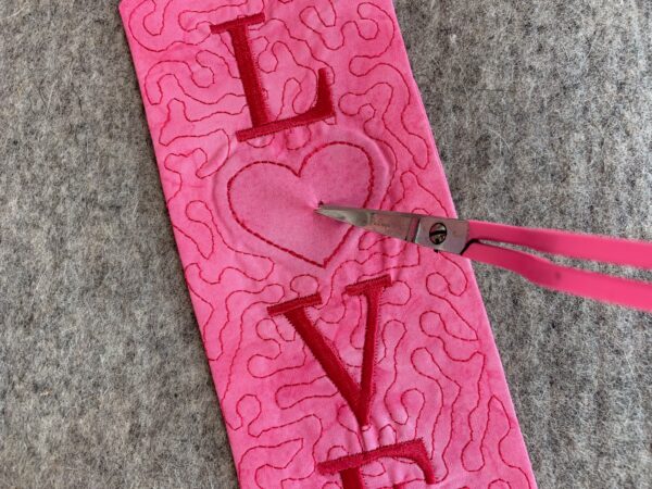 snip the fabric in the center of the heart