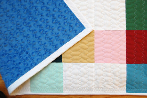Minki Backed Patchwork Baby Quilt tutorial at WeAllSew