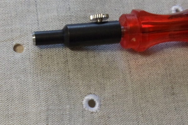 punching a hole to make an eyelet