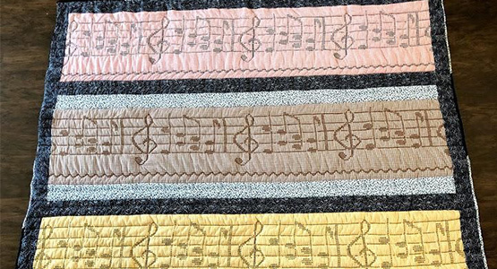 A Quilt made out of handmade dresses