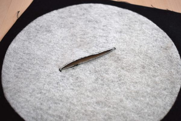 This step entails stitching a very tight straight stitch all around the mark you made on the top of the fabric with the fusible fleece circle fused to the back. This tight stitching will allow you to cut an opening inside the stitches to turn the record inside out with very little distortion.
