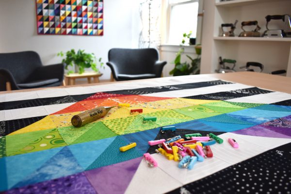 I begin pinning in the center of the quilt, working out to the edges.