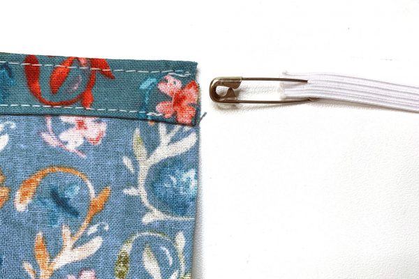 Attach safety pin to elastic and insert into casing