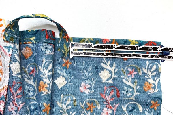 Place other end of strap 4-1/4" from center back, pin