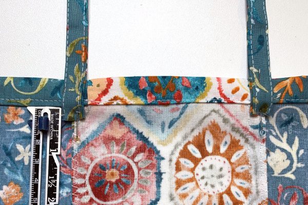 Place straps on inside of dress along center front panel seams and pin