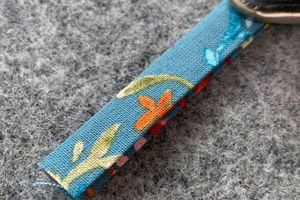 Fold Strap in half lengthwise again and press
