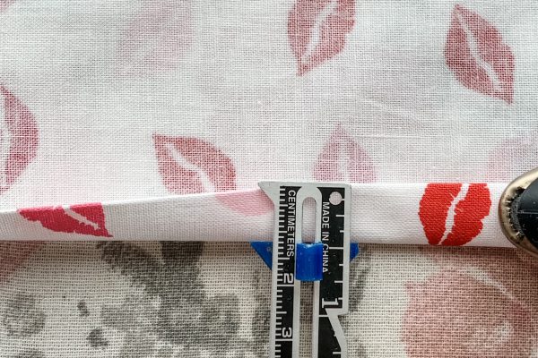 Press a double 1/4" hem on each apron side