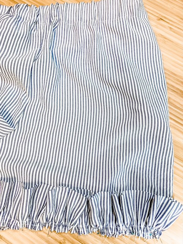 Pin ruffle to bottom of shorts raw edges matching