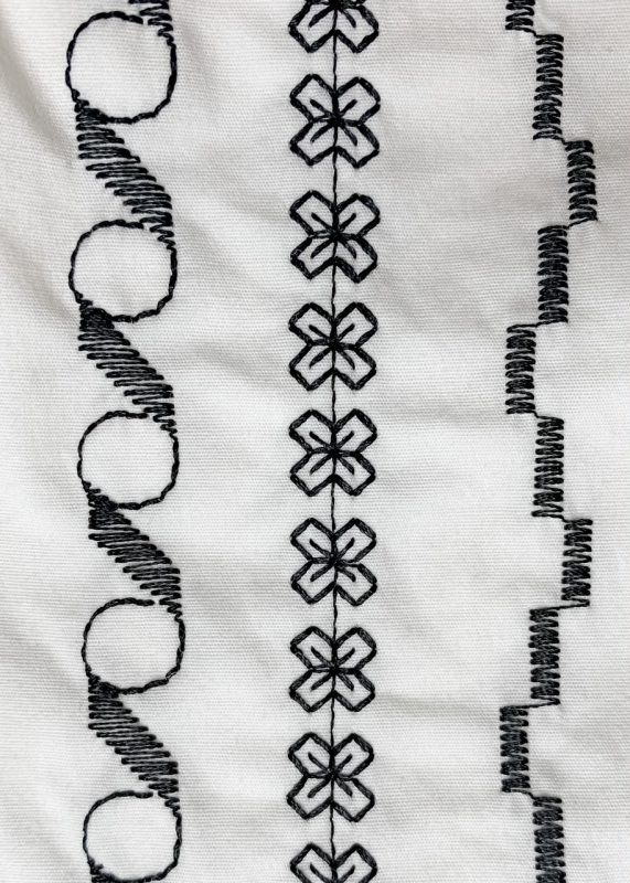 Three LInes of Decorative Stitches on White Shorts
