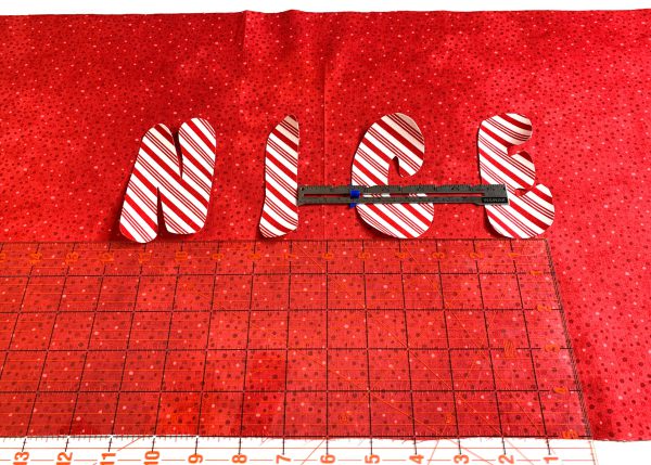 Place letters for word nice centered on pillow wrap