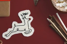 Machine embroidered feltie featuring a stylized reindeer design.