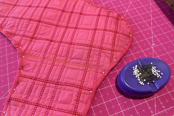 Couched Christmas Stocking- Pinning the binding to finish the bound interior seam