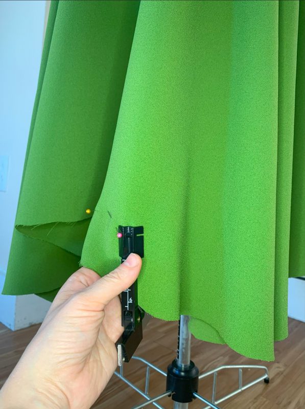 Green skirt with marking hem marking gauge on mannequin