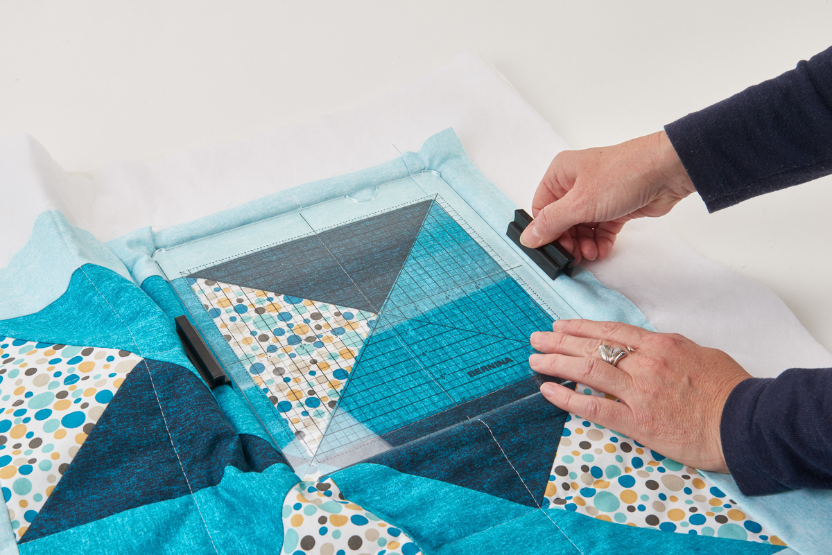 using clamp hoops on a multi-colored blue quilt.