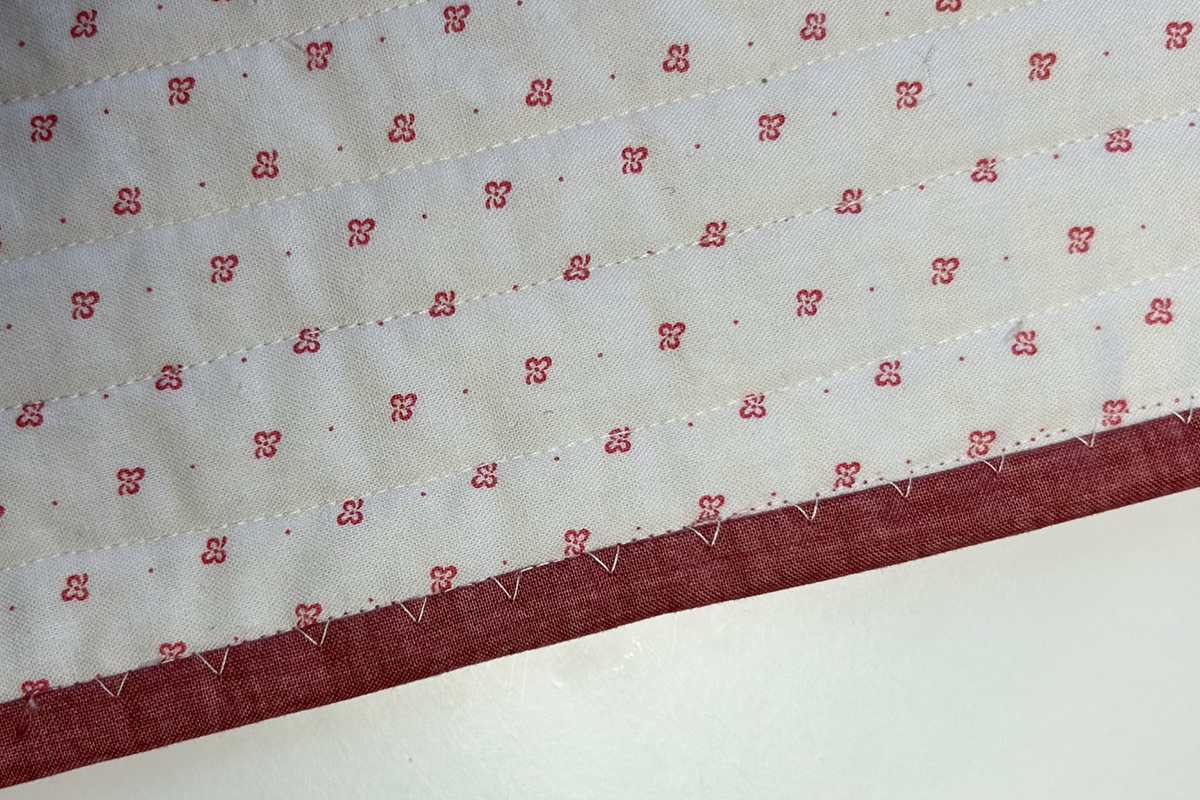 Blindstitch_Binding_08_White_Stitch_on_Red_BERNINA_WeAllSew_Blog_1200x800px