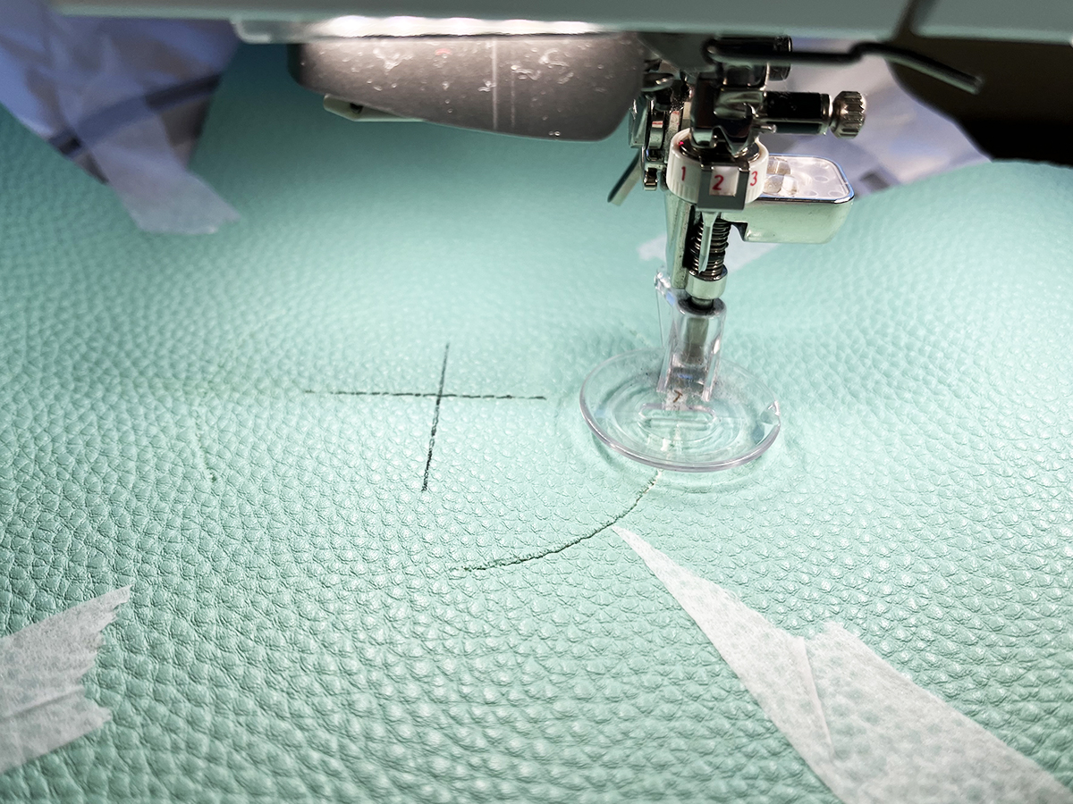 Up-close view of CutWork Tool, Echo Quilting and CutWork Foot #44C cutting a circle in vinyl 