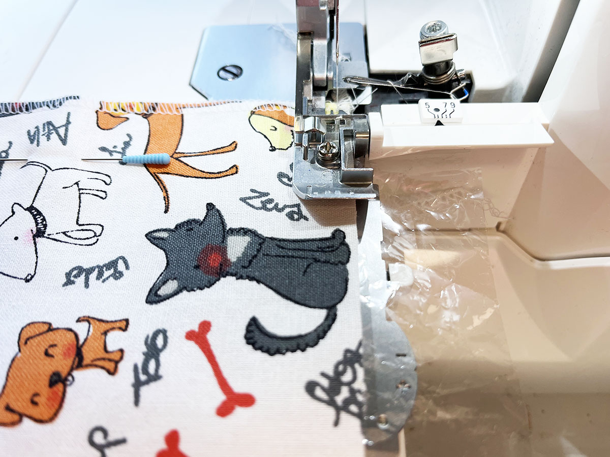 Close-up view of Close-up view of BERNINA L 460 serger with edge of squares with animal print fabric