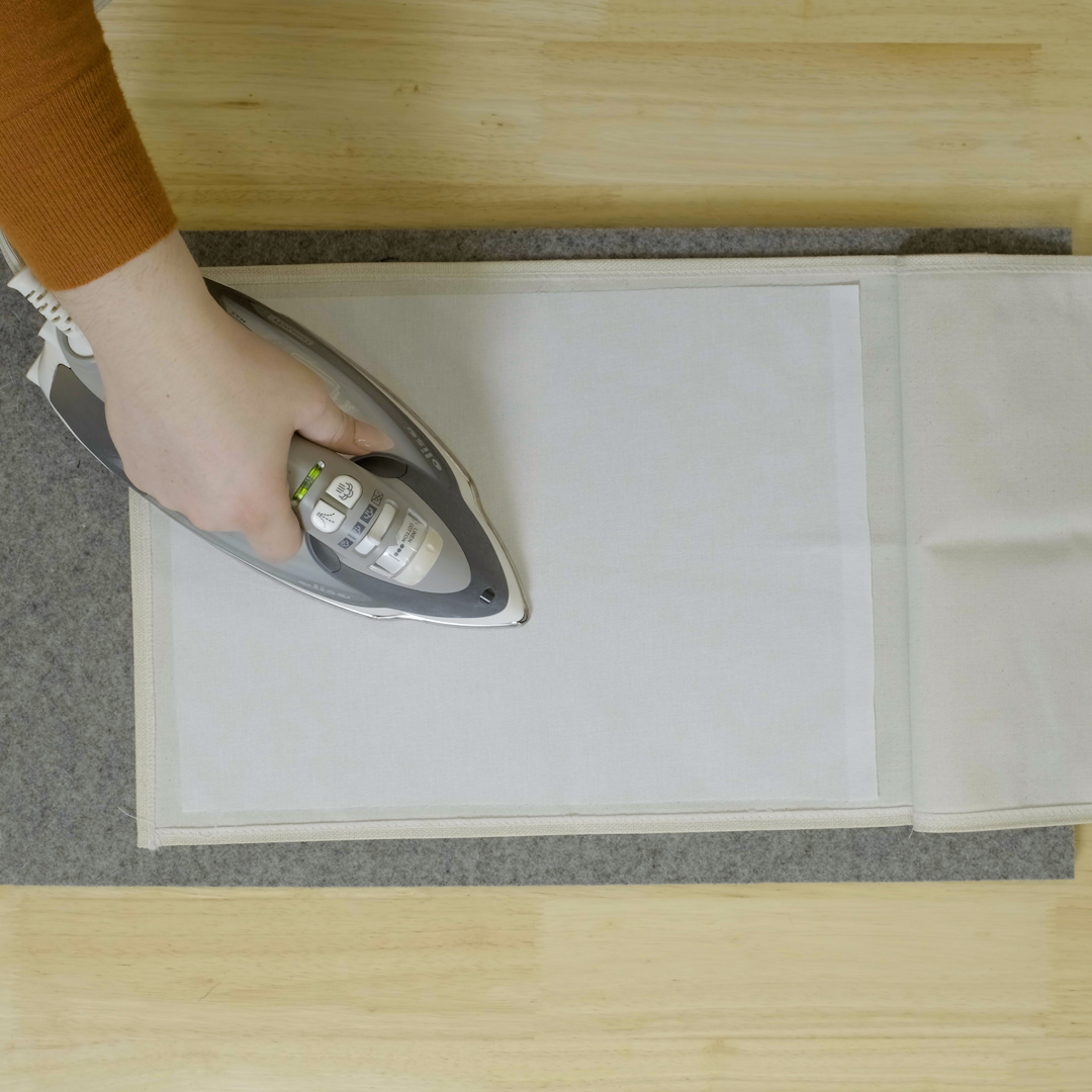 OESD Fusible Woven being ironed onto flag's wrong side