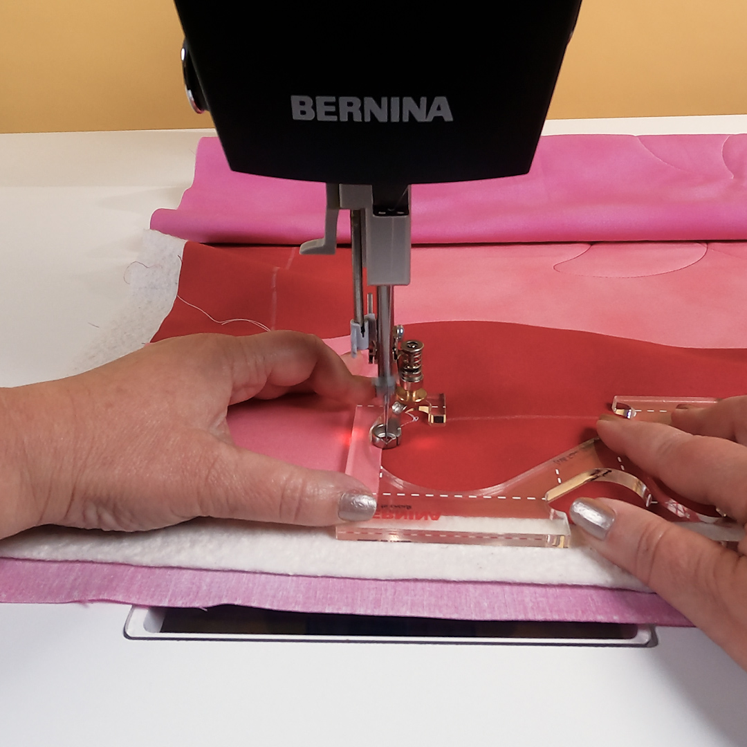 Up-close view of stitching heart being stitched using the ruler guide