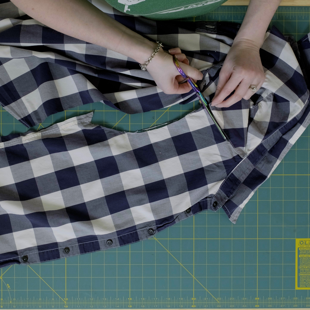 Scissors used to cut around shoulder of shirt