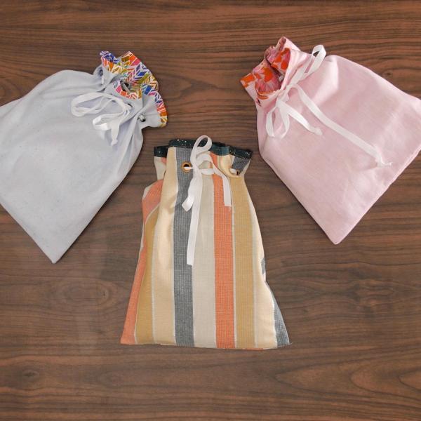 Three multi-colored drawstring bags