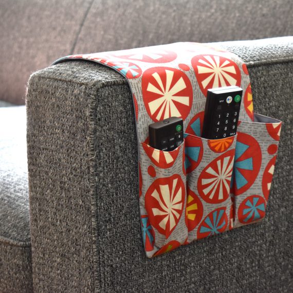 Colorful remote caddy hanging over side of couch