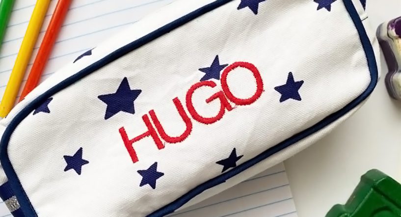 Pencil case on notebook with pencils